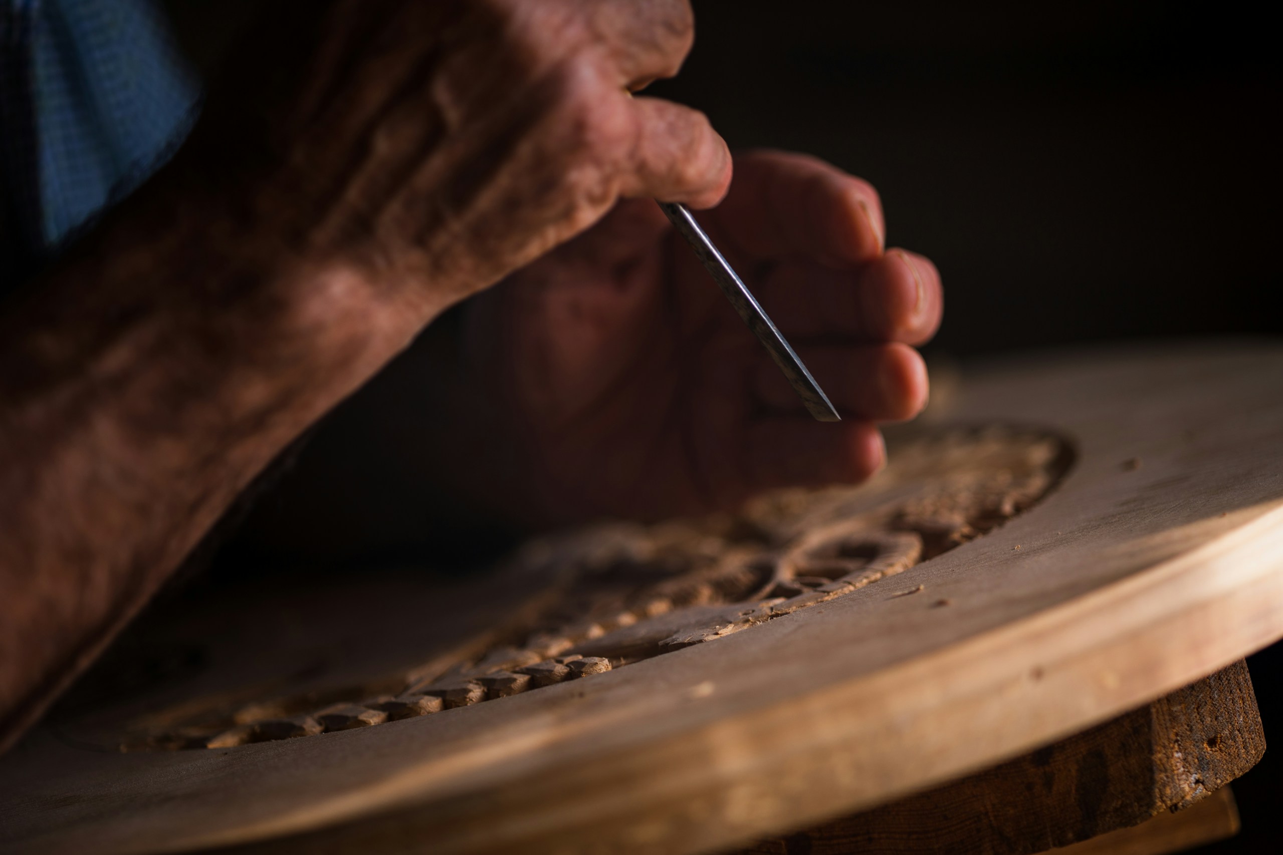 a person cutting a piece of wood with power tools in a workshop